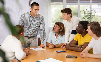 Group of men discussing something at a desk in the audience