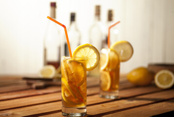 Refreshing iced tea with lemon on wooden table