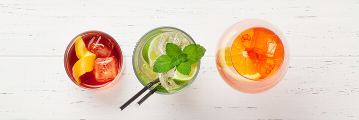 Refreshing trio of summer cocktails on white wooden background