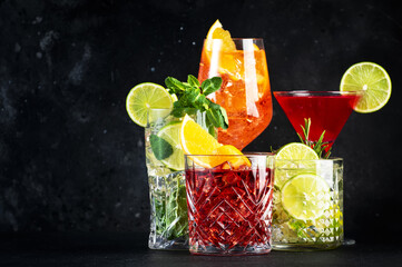 Assorted colorful cocktails on dark background