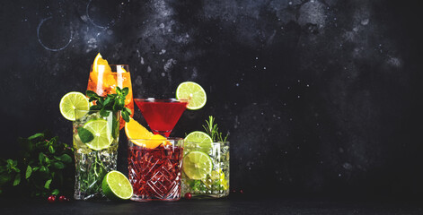 Refreshing assorted cocktail drinks on dark background