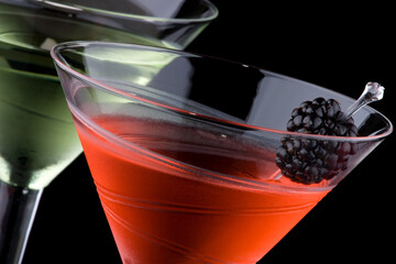 Elegant red cocktail with blackberry garnish