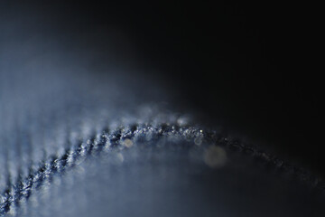 Macro of dandruff on shirt. Dandruff flakes are larger and may be yellow tinged or look oily