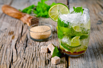 Fresh mojito cocktail on rustic table