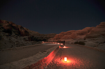 Nighttime path illuminated by candle lights