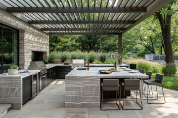 Fototapeta premium Luxurious outdoor kitchen with stainless steel appliances and a spacious dining table set in a beautifully landscaped backyard with greenery