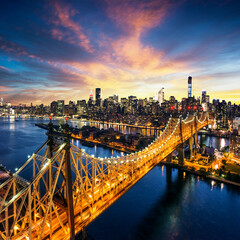 Majestic sunset over new york cityscape and bridge
