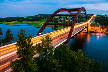 Illuminated bridge at twilight with city lights