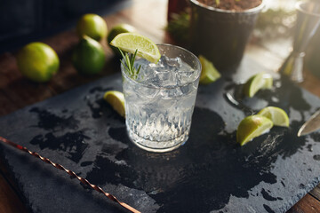 Refreshing lime cocktail on rustic slate coaster