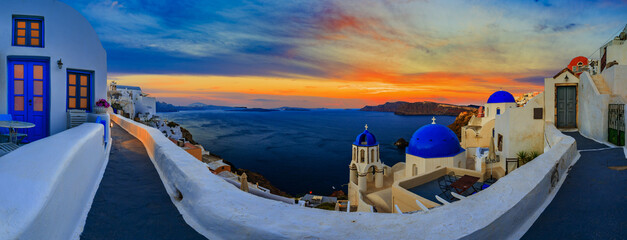 Santorini sunset panorama with blue domes