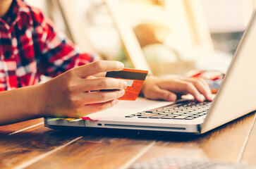 Online shopping with credit card and laptop