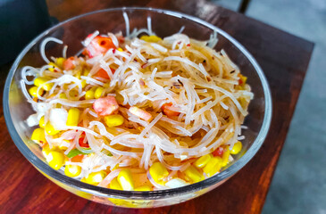 Dish of glass noodles with corn onions and tomatoes Mexico.