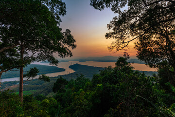 The close-up natural background of green rice fields, behind a large mountain and mist flowing through the blurred foliage, is a natural beauty seen in the countryside