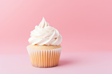 Simple birthday cupcake on a solid light pink background with empty space on the left