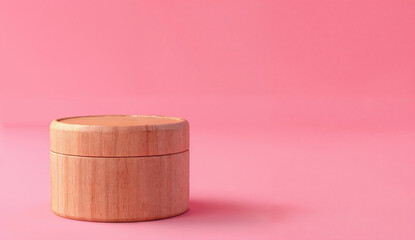Wooden cylinder podium for cosmetics display on a pink background with copy space. Ideal for product presentation in beauty and skincare advertising design