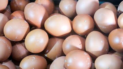 bunch of fresh brown chicken eggs in wooden crate ready to sell in the grocery market
