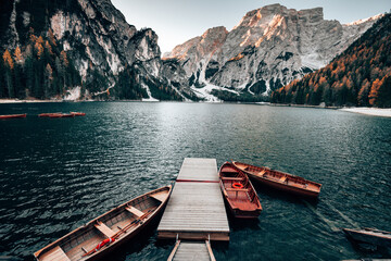 Peaceful alpine lake with wooden boats