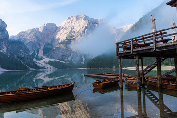 Tranquil mountain lake with wooden boats