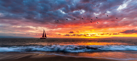 Sunset sailboat journey with birds and waves