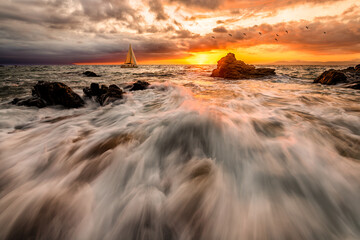 Sunset sailing: seascape with rushing waves and yacht