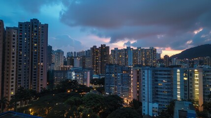 A view of the apartment from the balcony. The balcony overlooks a city skyline. The city skyline is lit up at night, and it is a beautiful sight.
