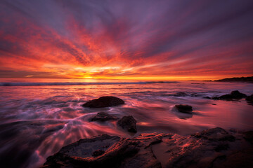 Majestic sunset over rocky shoreline