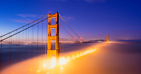 Golden gate bridge shrouded in mist at twilight