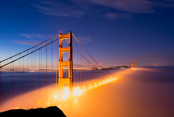 Golden gate bridge enveloped in fog at twilight
