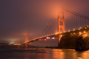 Misty golden gate bridge at night
