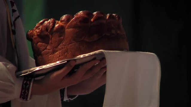 A Waiter Ceremonially Carrying a Cake During an Event or Celebration. Close up.