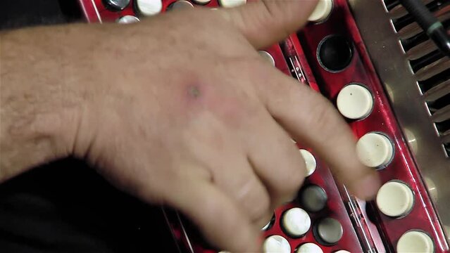 A Man Playing a Button Accordion. Close Up. 