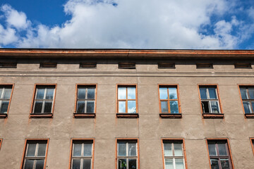 Main facade of an abandoned decaying industrial building, abandoned, in Jelgava, latvia. it's a symbol of economic crisis and transition in Eastern Europe.