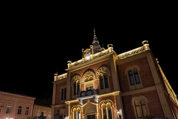 Selective blur on Vladicanski Dvor, the Bishop Episcopal palace with typical Austro hungarian architecture, at night in Novi Sad, Serbia, a landmark of the city center of Novi Sad.