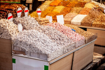 Selective blur on turkish delights, or rahalt lokum, for sale at a stall of Istanbul Misir Carsisi spice market. Lokum is an ottoman traditional confection sweet.