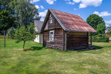 Small Rural Rustic Wooden House Standing In A Garden Lawn