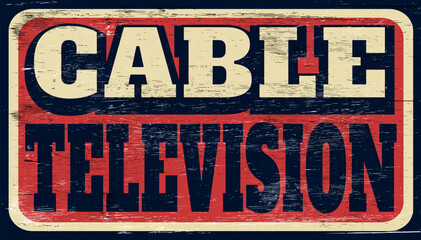Aged retro cable television sign on wood