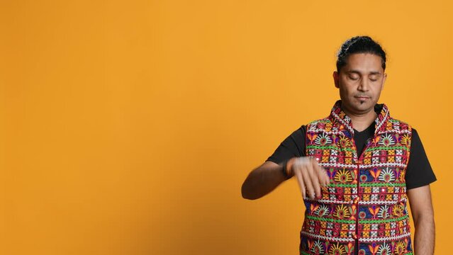 Indian man doing ok hand sign, feeling pleased, agreeing with satisfactory conclusion. Optimistic person doing okay symbol gesturing, offering positive feedback, studio background, camera A