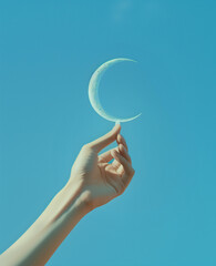 A hand touching the moon in the sky..Minimal creative nature,environment  and business concept.