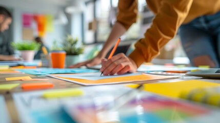 Obraz premium Close-up view of a project planning with a creative team, using colorful sticky notes and documents on a table, creative team engaged in project planning and brainstorming, business teamwork.