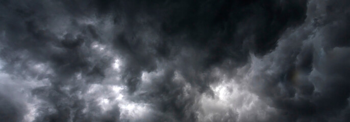 Banner Dramatic dark storm clouds black sky background. Dark thunderstorm clouds rainny season. Panorama Meteorology danger windstorm disasters climate. Dark cloudscape storm cloud with copy space. - Powered by Adobe