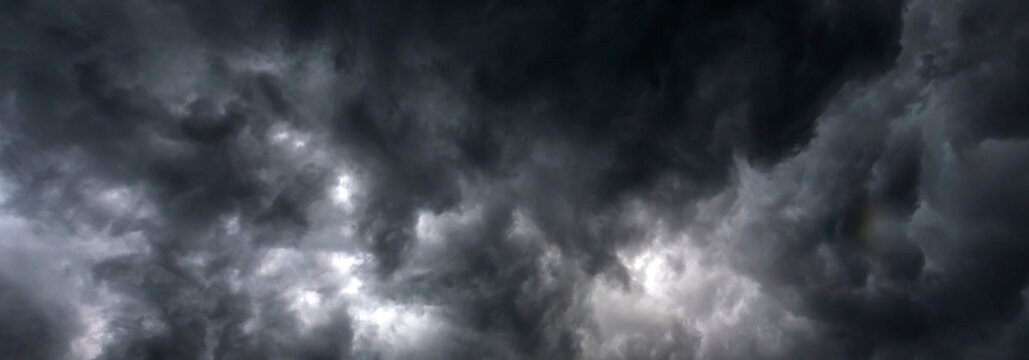 Banner Dramatic dark storm clouds black sky background. Dark thunderstorm clouds rainny season. Panorama Meteorology danger windstorm disasters climate. Dark cloudscape storm cloud with copy space.