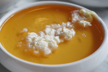 butter cream and honey in a bowl on table .