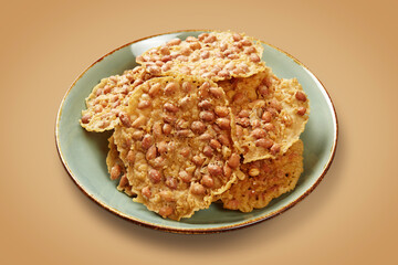 Peyek Kacang is a type of cracker made from a mixture of rice flour and peanuts that is fried until crispy