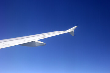 View of sky and wing of airplane from window