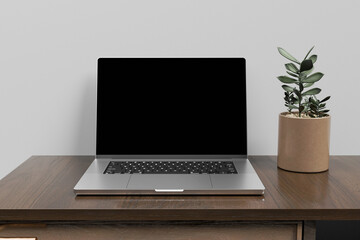 Front view of blank screen laptop on wooden table. 3d rendering