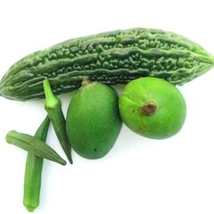Bitter melon, okra and green mangoes with white background. Bitter melon has other many other benefits. 