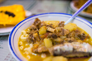 Macaroni tomato soup with fish and meat at Macau local restaurant.