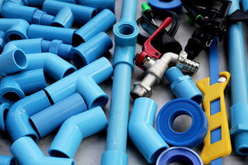 Plumber equipment with blue pvc pipe connections for plumbing work.