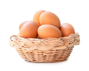 Front view of brown chicken eggs in stack in wicker basket isolated with clipping path and shadow in png file format