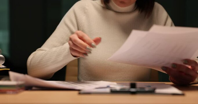 Woman entrepreneur reviews financial report at work